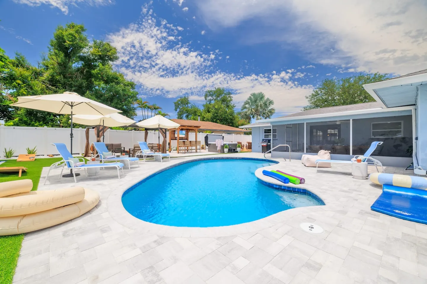The Breezy Palm: pool and paver patio