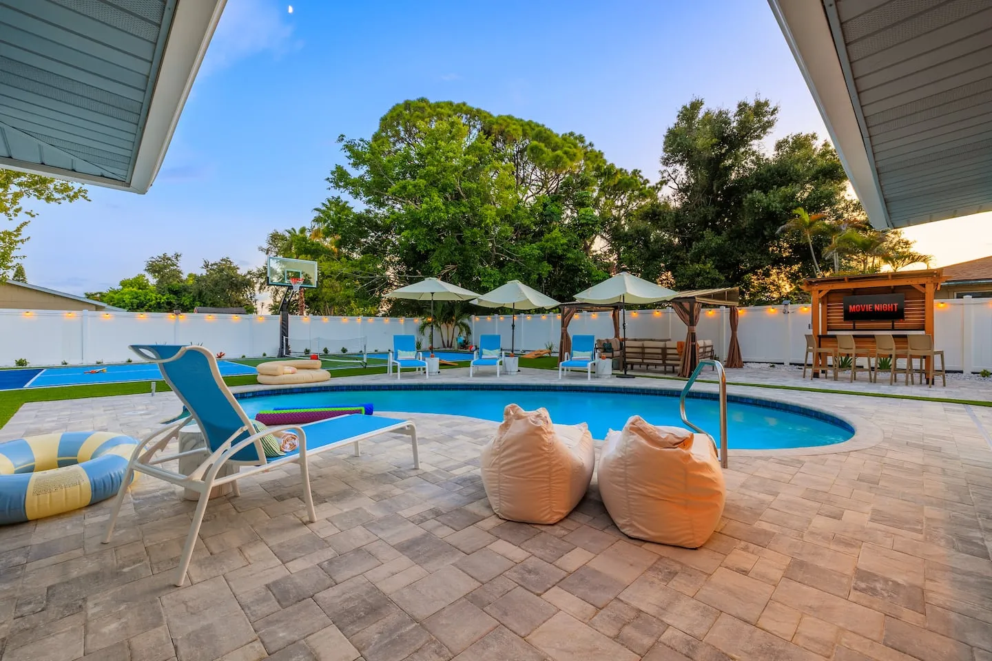 The Breezy Palm: pool with loungers