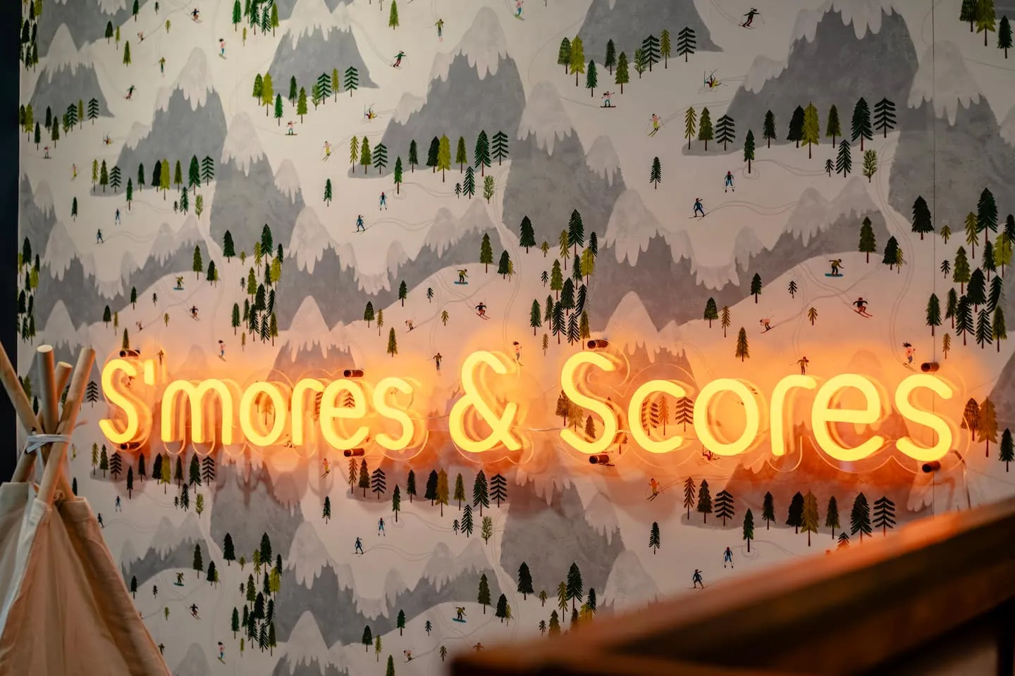 Honey Hollow: S'mores and Scores neon sign in the game room